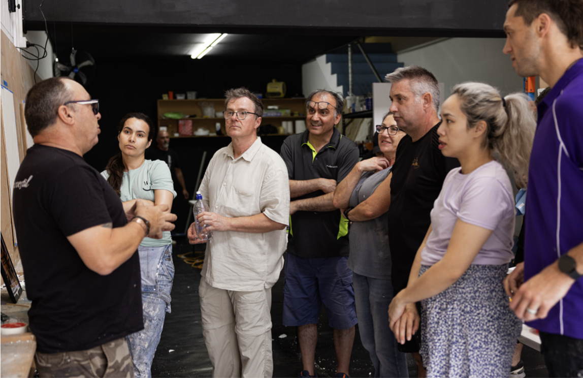 Trainer talking a group through a decorative finishes workshop