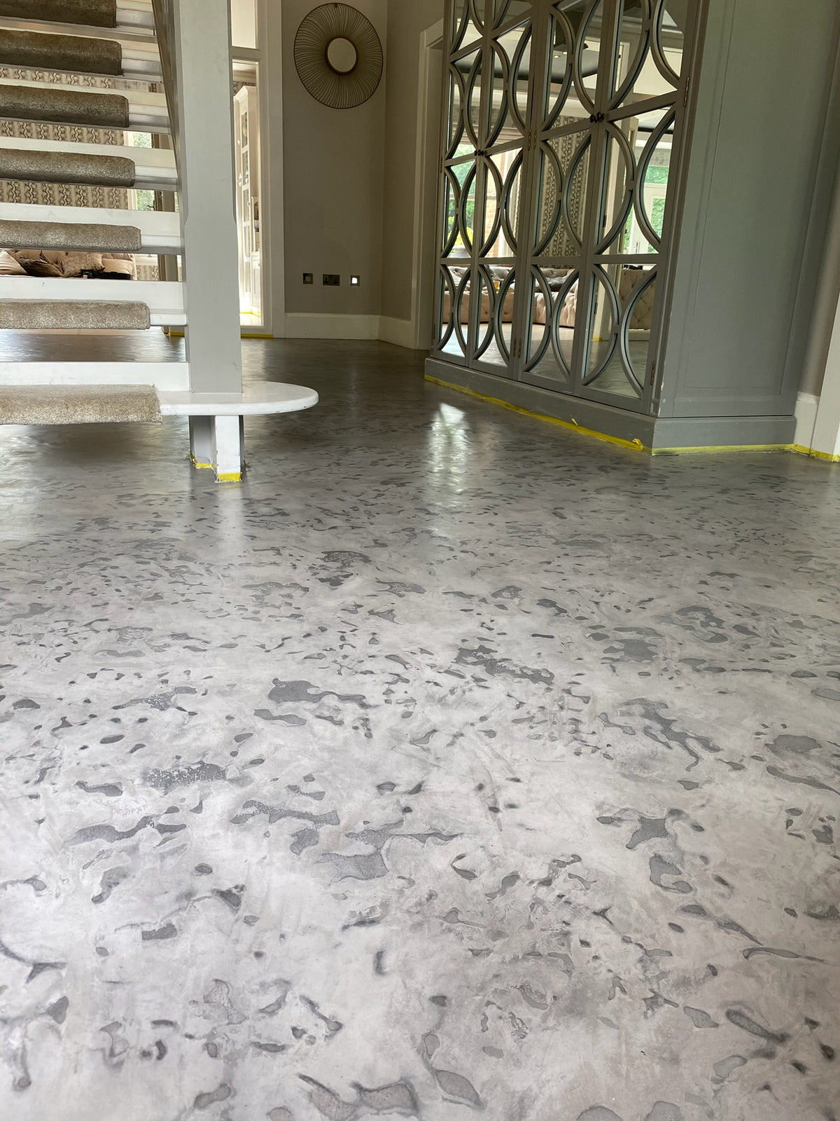 Hallway with a hand-trowelled grey microcement floor