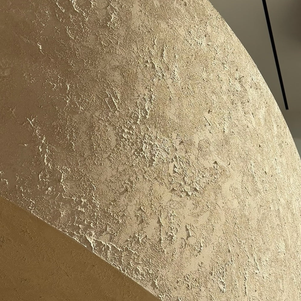 Close-up of a gold textured plaster finish on a curved wall