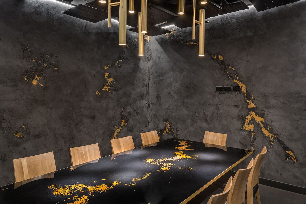 Private dining room with dark plaster walls and gold liquid metal veining